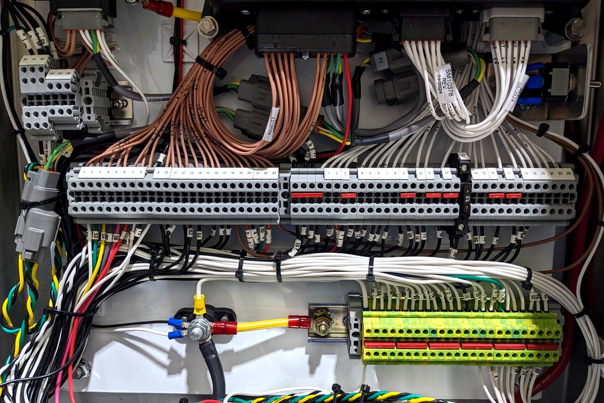 QCS box build interior — DIN rail terminal blocks and panel wiring assembled